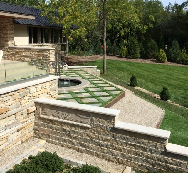 Design ideas for a large contemporary backyard full sun formal garden for summer in Milwaukee with a water feature and natural stone pavers.