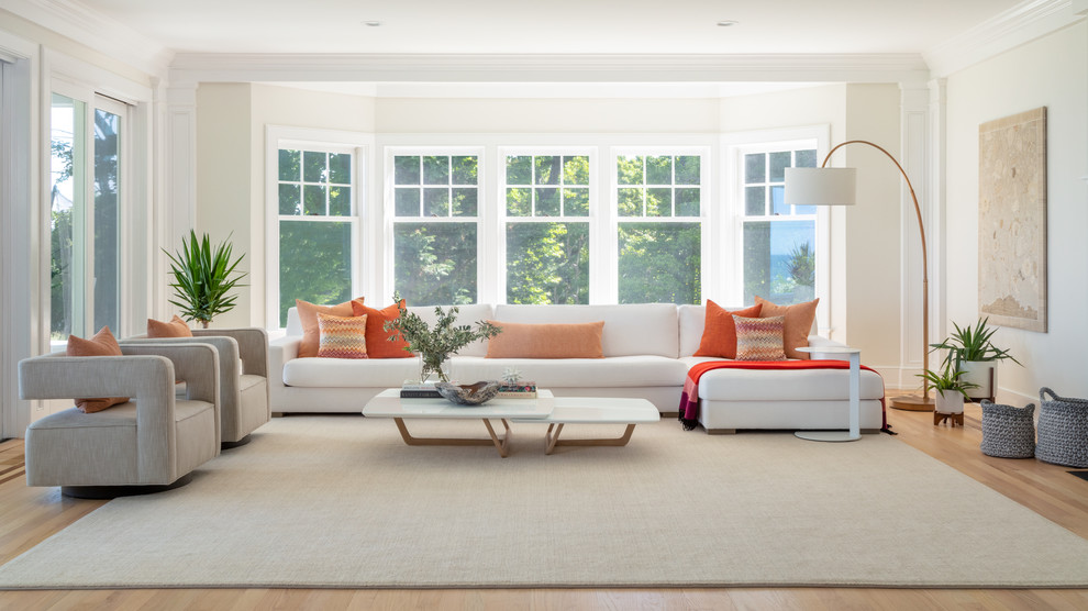 Design ideas for a scandinavian living room in New York with white walls, light hardwood floors and beige floor.