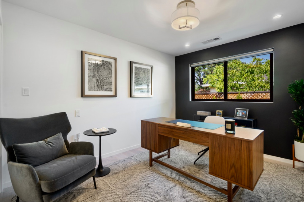 Idee per un piccolo ufficio country con pareti nere, parquet chiaro e scrivania autoportante