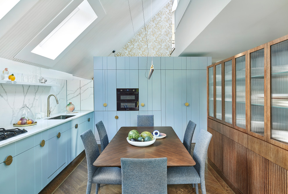 Design ideas for a medium sized contemporary grey and teal l-shaped kitchen/diner with a submerged sink, flat-panel cabinets, turquoise cabinets, composite countertops, red splashback, black appliances, medium hardwood flooring, no island, white worktops and a vaulted ceiling.