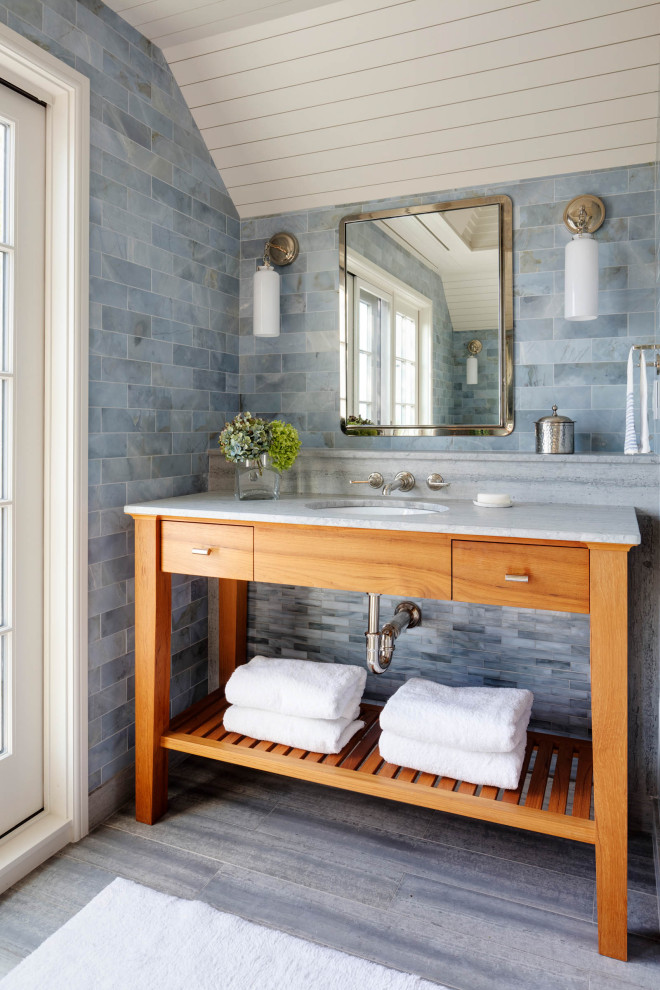 This is an example of a beach style bathroom in Boston with open cabinets, medium wood cabinets, blue tile, an undermount sink, grey floor, white benchtops, a single vanity, a freestanding vanity, timber and vaulted.