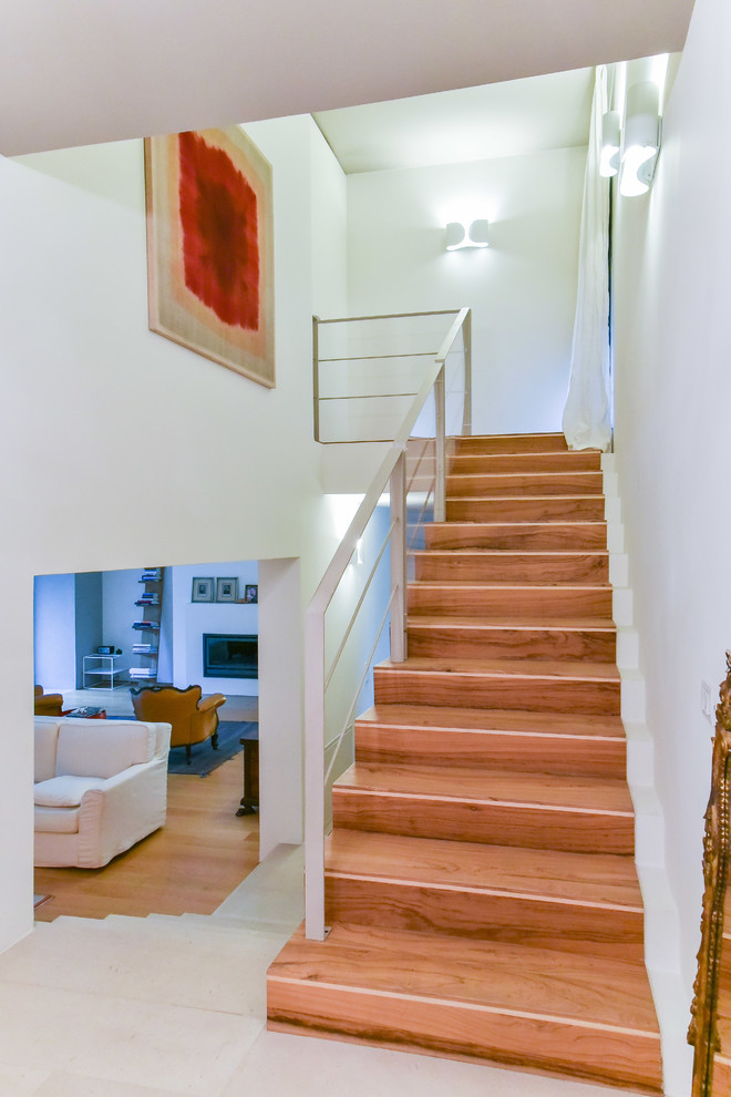 Design ideas for a mid-sized contemporary wood straight staircase in Venice with wood risers.