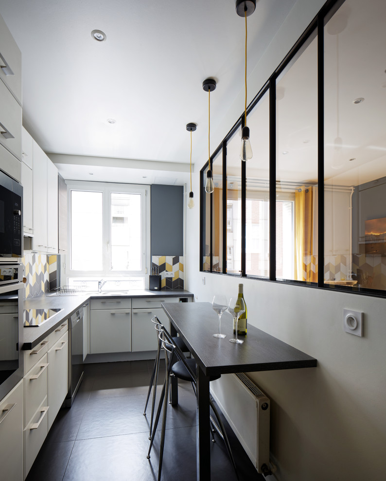 Mid-sized contemporary l-shaped kitchen in Paris with white cabinets, laminate benchtops, yellow splashback, ceramic splashback and stainless steel appliances.