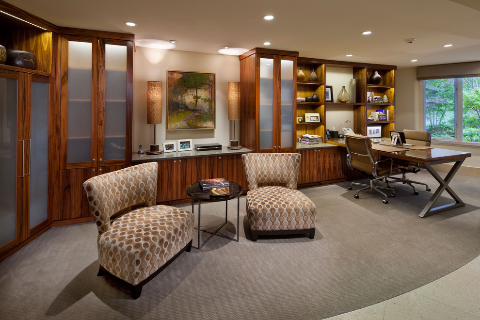 This is an example of a traditional home office in Grand Rapids with carpet and a built-in desk.