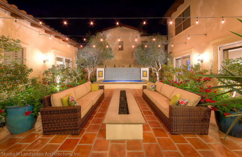 Design ideas for a mid-sized mediterranean courtyard patio in Orange County.