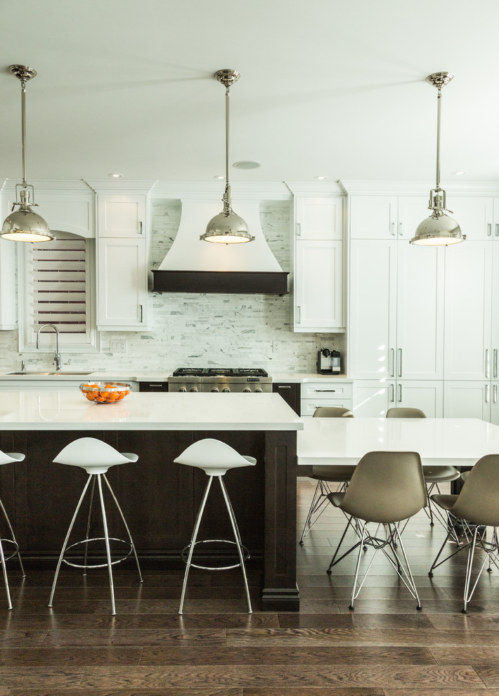 Photo of a transitional kitchen in Toronto with an undermount sink, shaker cabinets, white cabinets, white splashback and stainless steel appliances.