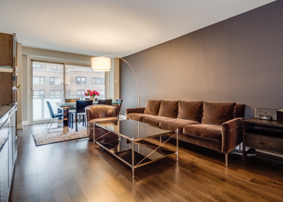 Inspiration for a mid-sized contemporary open concept dark wood floor and brown floor living room remodel in New York with a bar, gray walls, a wall-mounted tv and no fireplace