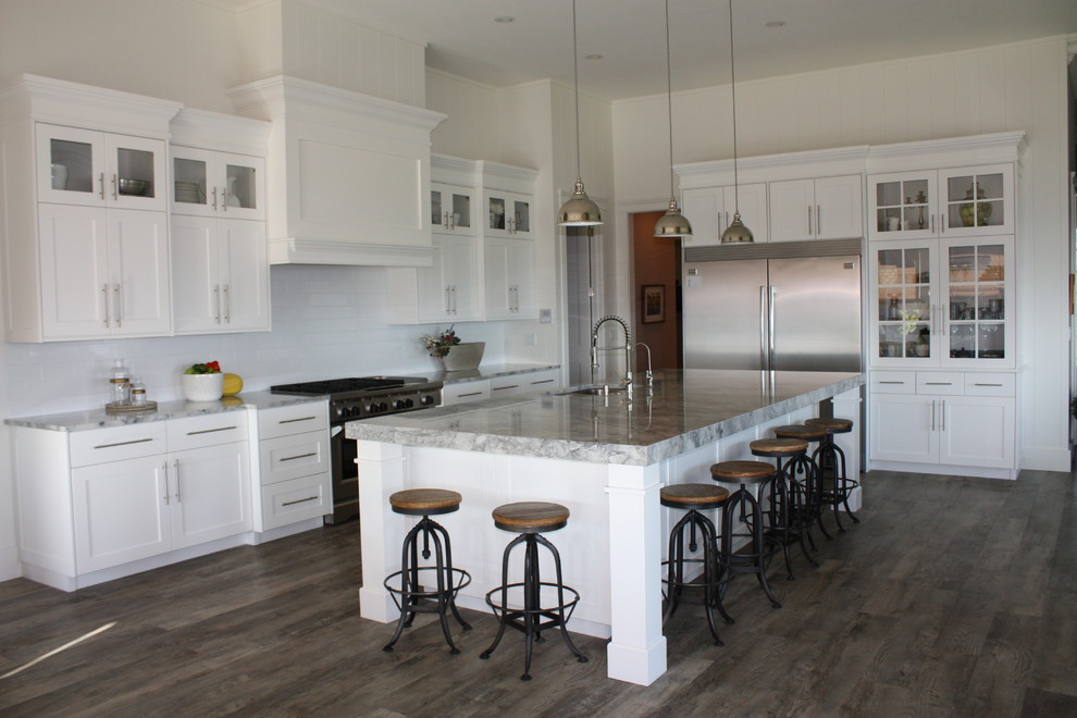 Inspiration for a large craftsman l-shaped dark wood floor open concept kitchen remodel with beaded inset cabinets, white cabinets, subway tile backsplash, stainless steel appliances, an island, an undermount sink and marble countertops