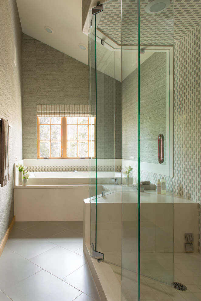 Inspiration for a transitional bathroom in Denver with a drop-in tub and gray tile.