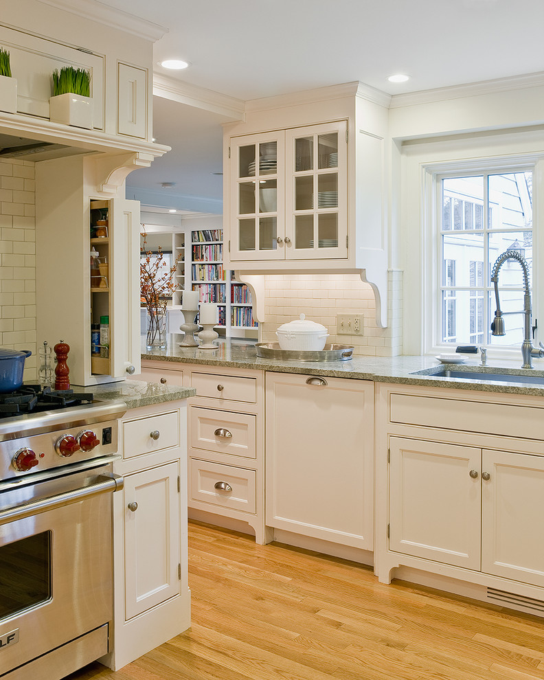 This is an example of a traditional kitchen in Boston with beaded inset cabinets, beige cabinets and green benchtop.