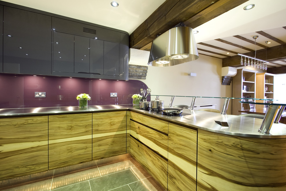 Design ideas for a contemporary kitchen in London with stainless steel benchtops and glass sheet splashback.