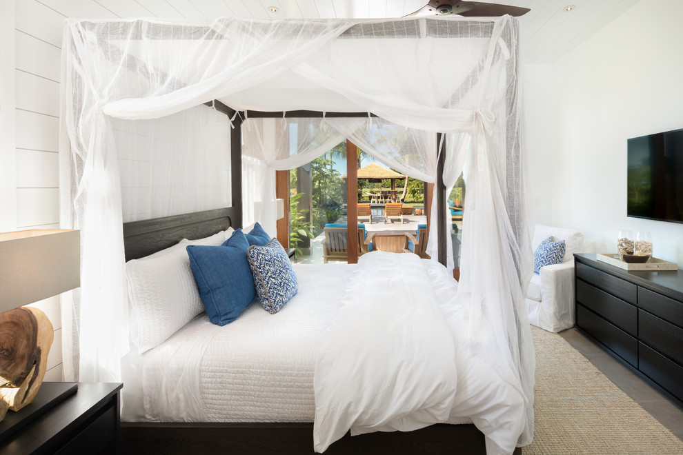 Mid-sized beach style guest bedroom in Hawaii with white walls, ceramic floors, no fireplace and grey floor.