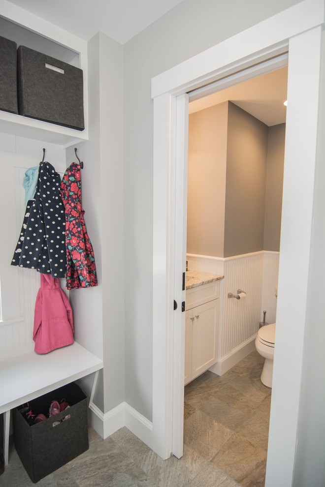 Photo of a small transitional powder room in Boston with shaker cabinets, white cabinets, a two-piece toilet, multi-coloured tile, grey walls, porcelain floors, an undermount sink and quartzite benchtops.