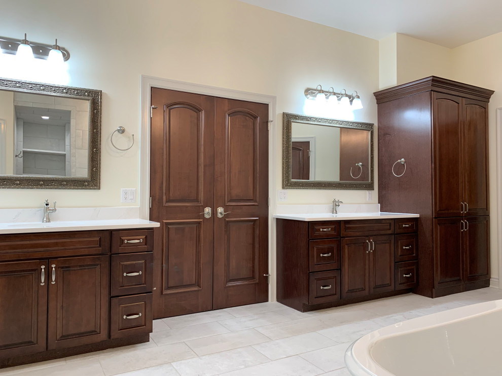 Expansive traditional master bathroom in Other with raised-panel cabinets, brown cabinets, engineered quartz benchtops, white benchtops, a double vanity and a built-in vanity.