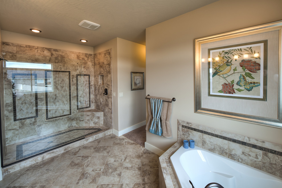 Drop-in bathtub - mid-sized transitional master beige tile, brown tile and travertine tile travertine floor and beige floor drop-in bathtub idea in Seattle with recessed-panel cabinets, dark wood cabinets, a two-piece toilet, beige walls, an undermount sink and granite countertops