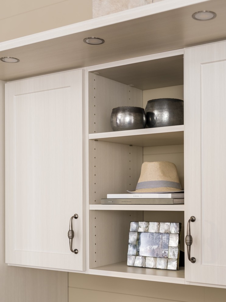 Dressing room - mid-sized transitional gender-neutral medium tone wood floor and brown floor dressing room idea in Chicago with shaker cabinets and white cabinets