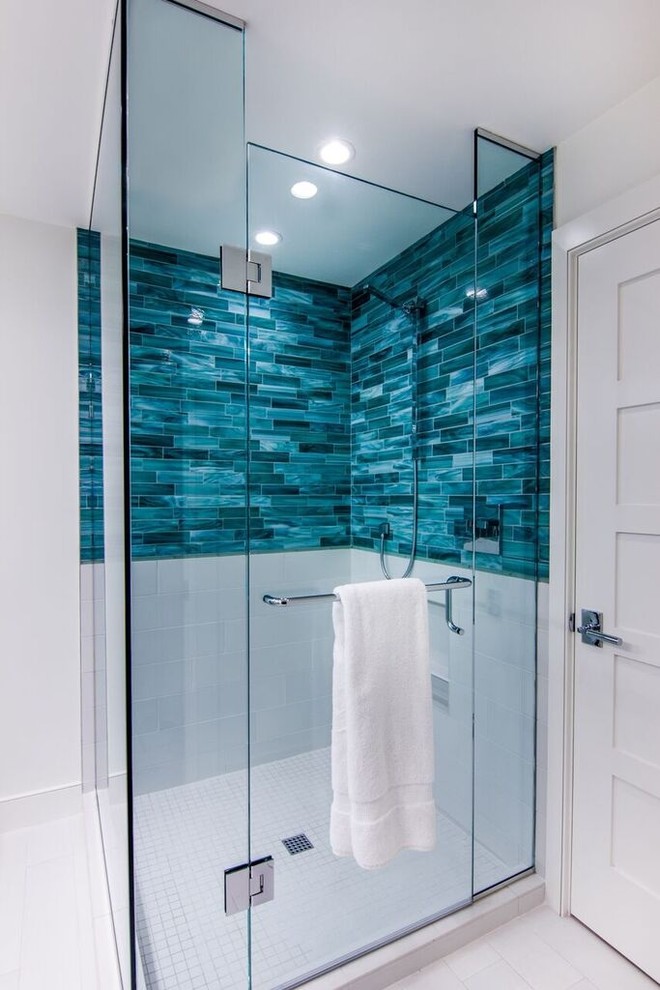 Photo of a contemporary bathroom in Miami with blue tile, subway tile, white walls, limestone floors and an open shower.
