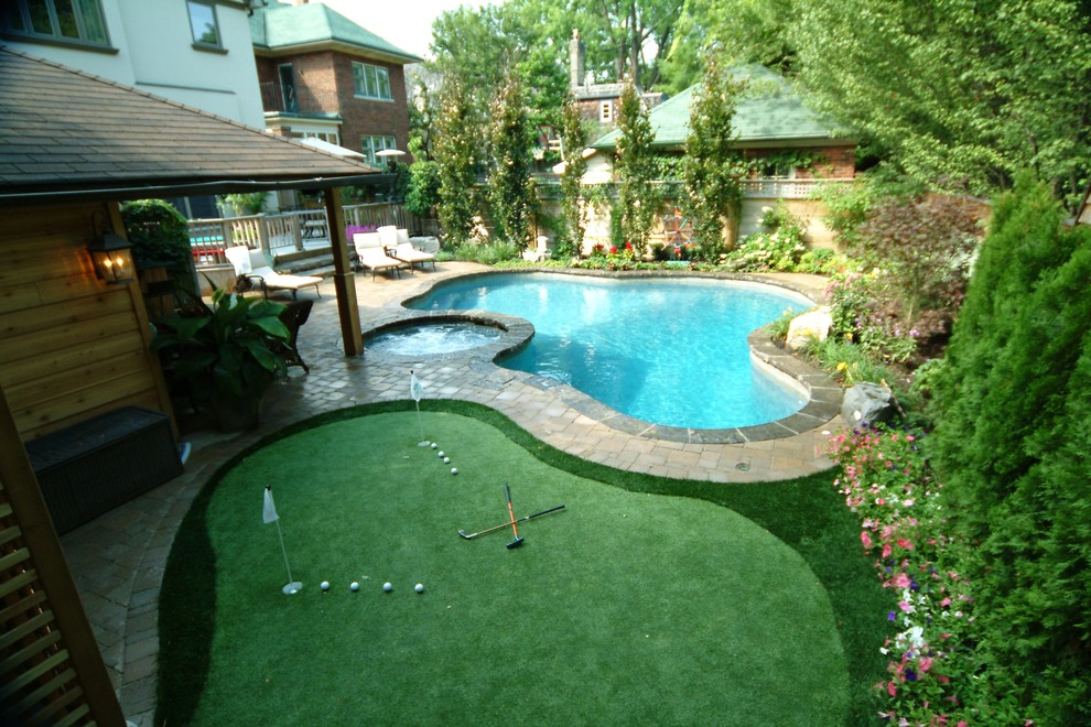 Pool - mid-sized traditional backyard concrete paver pool idea in Toronto