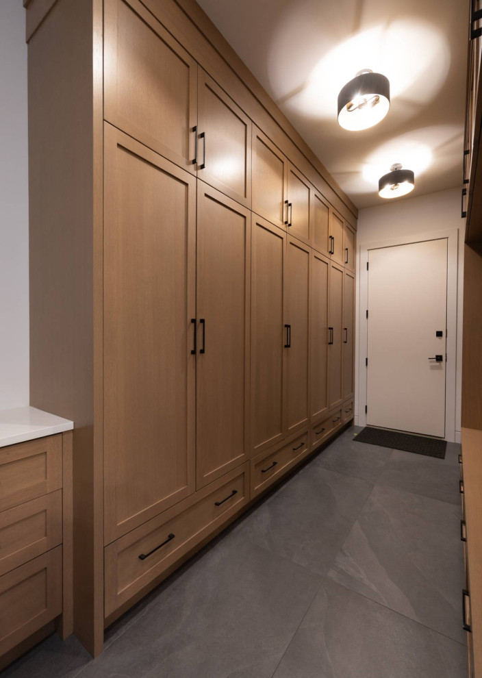 Mudroom - large contemporary porcelain tile and gray floor mudroom idea in Calgary with white walls