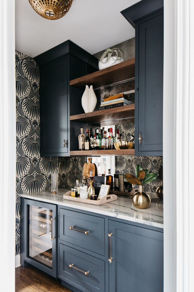 Example of a large transitional u-shaped medium tone wood floor eat-in kitchen design in Chicago with an undermount sink, recessed-panel cabinets, medium tone wood cabinets, quartzite countertops, beige backsplash, stone slab backsplash, stainless steel appliances, an island and beige countertops