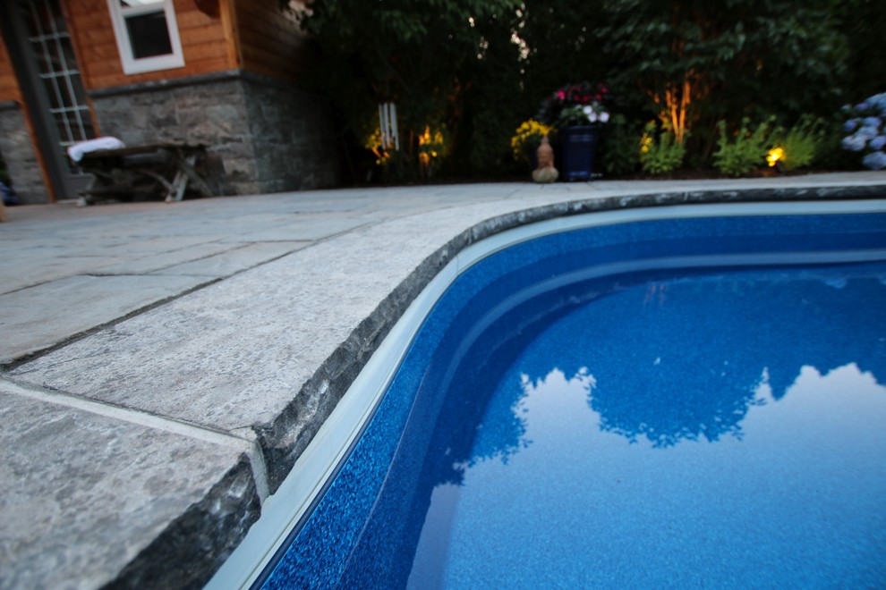 Pool - transitional backyard pool idea in Toronto