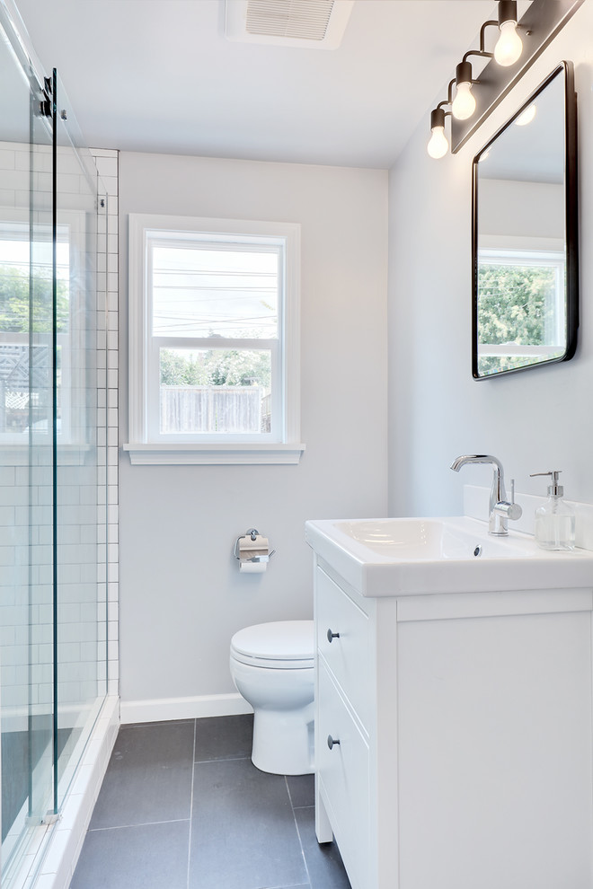 Inspiration for a small modern 3/4 bathroom in Seattle with flat-panel cabinets, white cabinets, an open shower, white tile, subway tile and white benchtops.