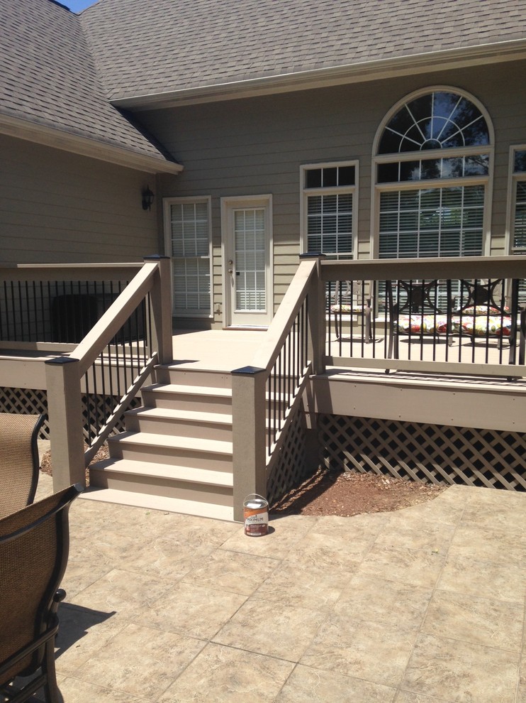 Example of a mid-sized classic backyard deck design with no cover
