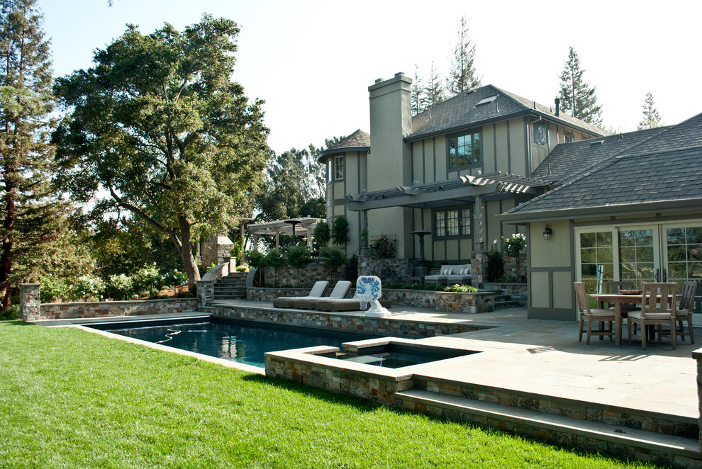 Photo of an expansive transitional front yard rectangular pool in San Francisco with natural stone pavers.