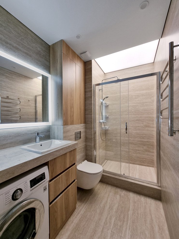 Inspiration for a mid-sized contemporary bathroom in Other with flat-panel cabinets, medium wood cabinets, a wall-mount toilet, beige tile, travertine, beige walls, porcelain floors, an undermount sink, beige floor, beige benchtops, a freestanding vanity and recessed.