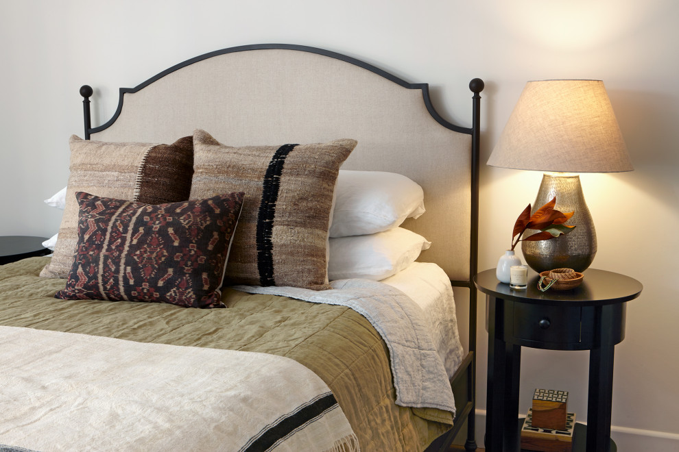 Foto de dormitorio principal mediterráneo pequeño con paredes blancas, suelo de madera en tonos medios y suelo marrón