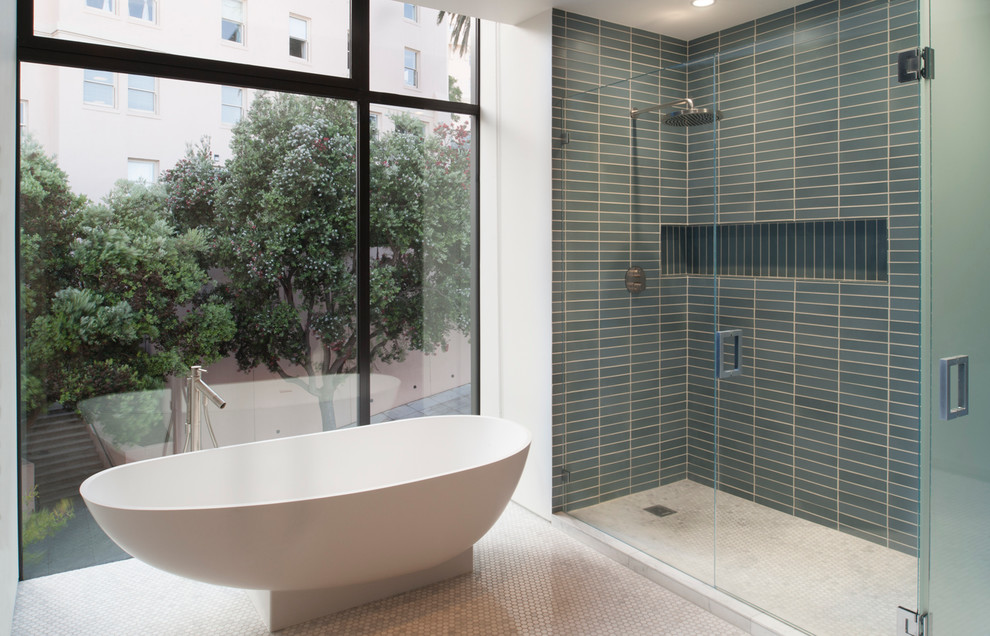 Design ideas for a mid-sized scandinavian master bathroom in San Francisco with flat-panel cabinets, white cabinets, marble benchtops, a freestanding tub, a corner shower, a one-piece toilet, blue tile, ceramic tile, white walls and marble floors.