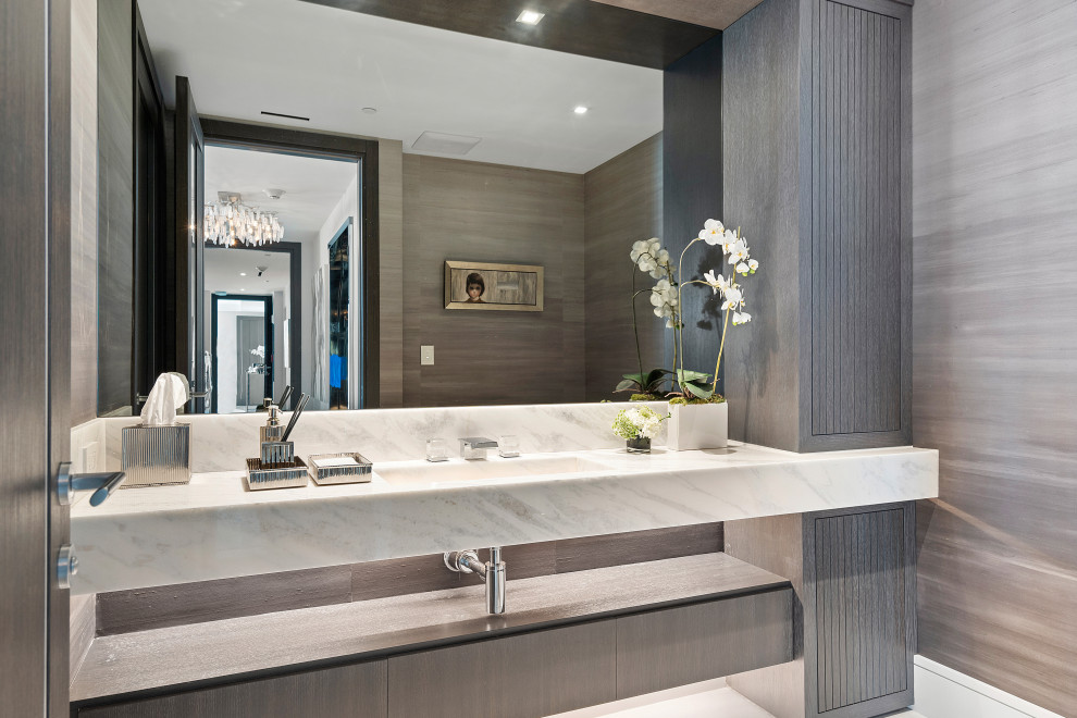 Photo of a medium sized contemporary cloakroom in Miami with dark wood cabinets, a bidet, grey walls, marble flooring, an integrated sink, marble worktops, white floors, white worktops, a floating vanity unit and wallpapered walls.