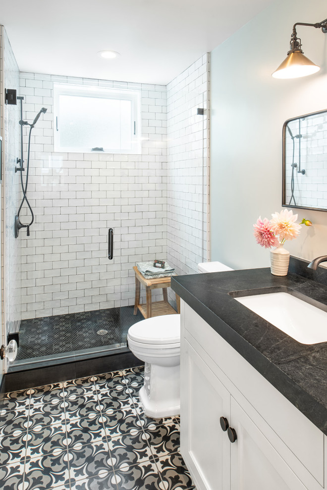 Design ideas for a country 3/4 bathroom in San Francisco with an alcove shower, ceramic tile, porcelain floors, a drop-in sink, black floor, a hinged shower door and a built-in vanity.