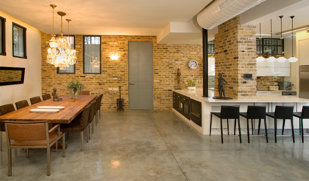 Industrial dining room in Other with concrete floors.