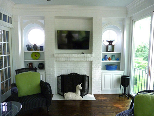 Photo of a mid-sized transitional sunroom in Raleigh with dark hardwood floors, a standard fireplace, a brick fireplace surround and a standard ceiling.