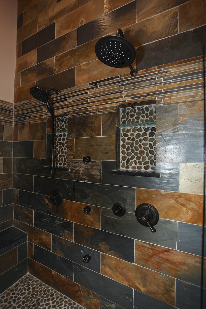 Large mountain style master slate tile brown floor freestanding bathtub photo in Indianapolis with brown cabinets, beige walls and an undermount sink
