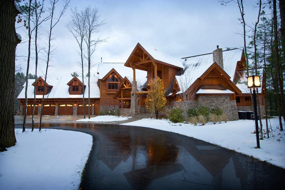 Inspiration for a rustic front yard stone driveway.