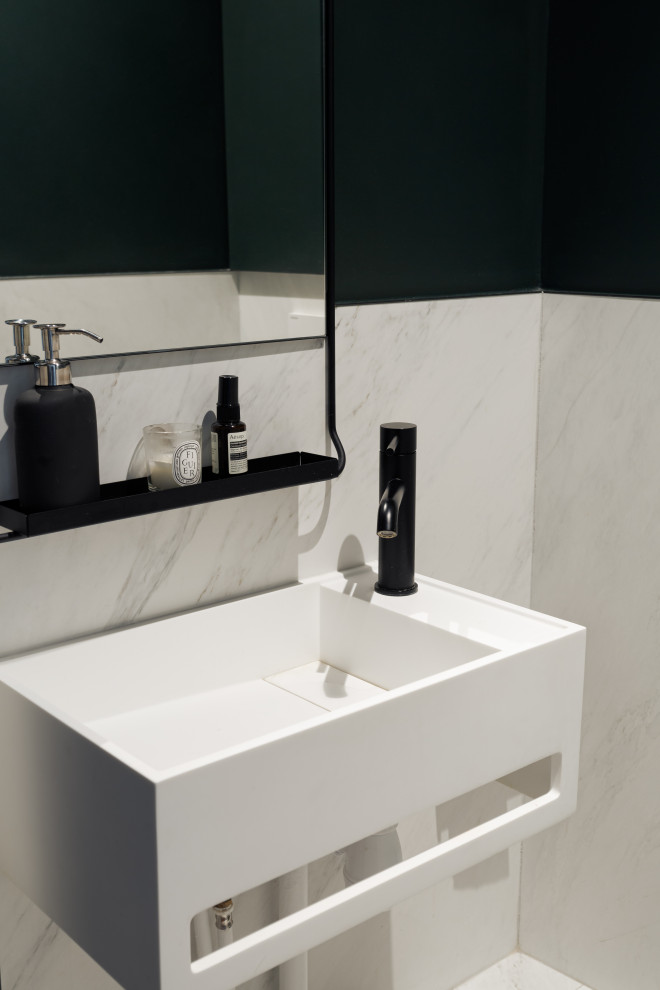Photo of a medium sized modern cloakroom in Paris with beaded cabinets, green cabinets, a wall mounted toilet, white tiles, marble tiles, green walls, marble flooring, a wall-mounted sink, quartz worktops, white floors, white worktops and a floating vanity unit.