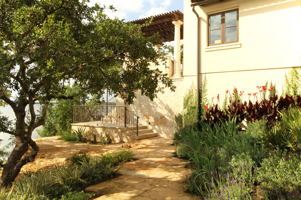 Inspiration for a mid-sized mediterranean backyard garden in Austin with gravel.