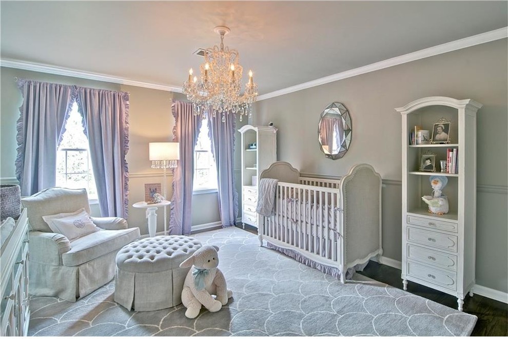 Inspiration for a large transitional nursery for girls in Atlanta with grey walls, medium hardwood floors and brown floor.