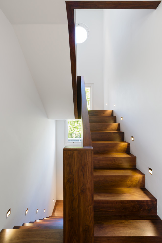 Inspiration for a mid-sized contemporary wood u-shaped staircase in London with wood risers.