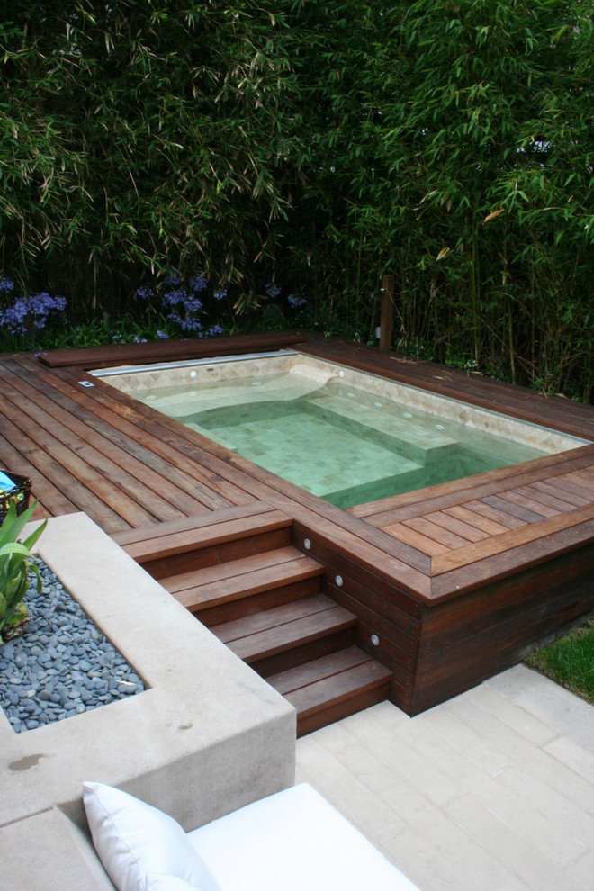 Inspiration for a large contemporary backyard rectangular pool in San Francisco with a hot tub and decking.