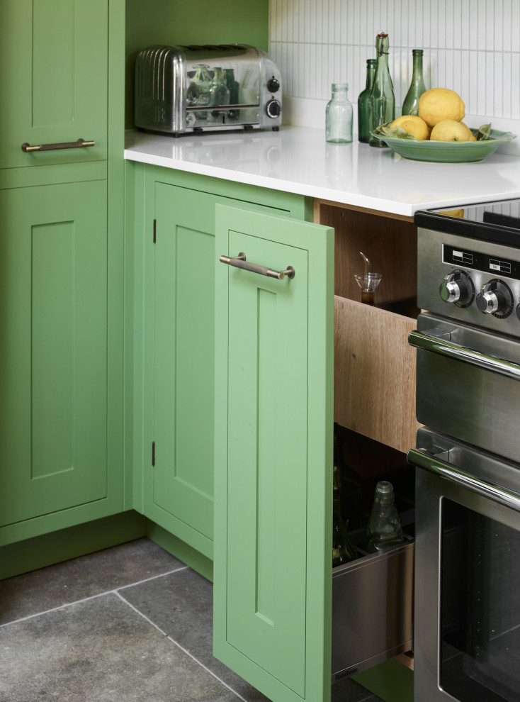 Inspiration for a rural u-shaped open plan kitchen in London with green cabinets, an island and white worktops.