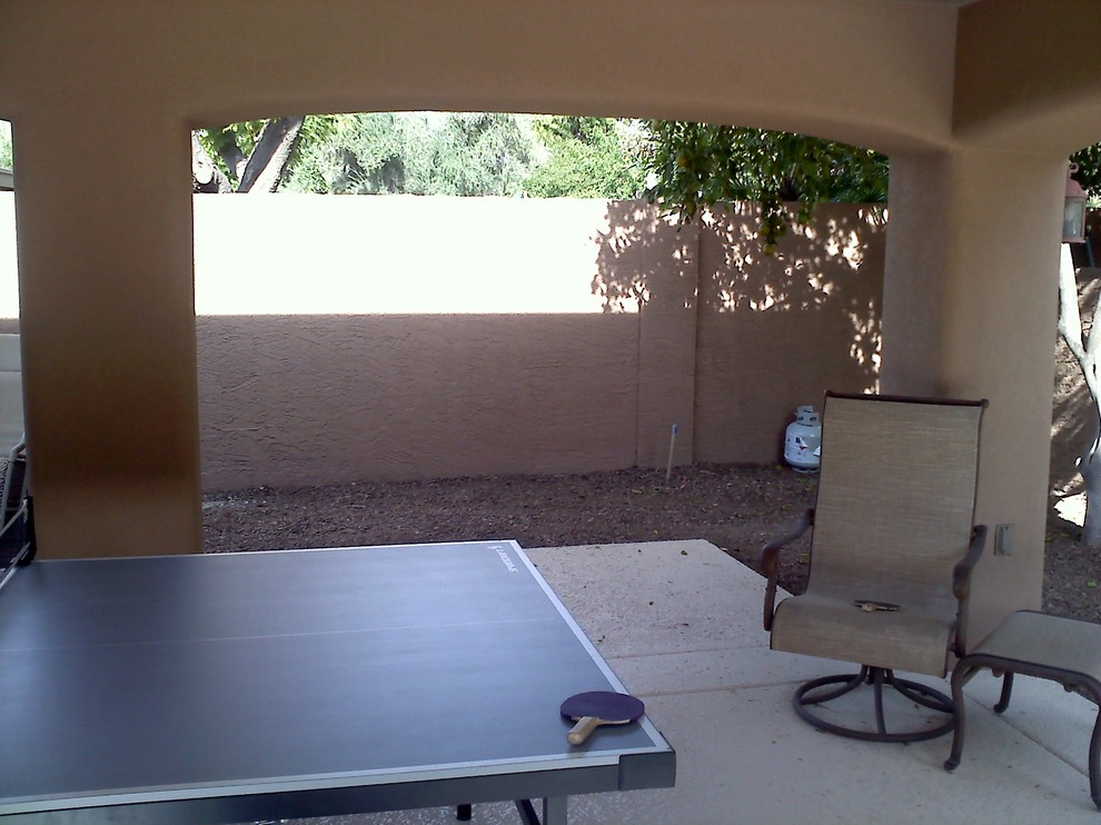 Inspiration for a transitional backyard concrete patio remodel in Phoenix with a roof extension