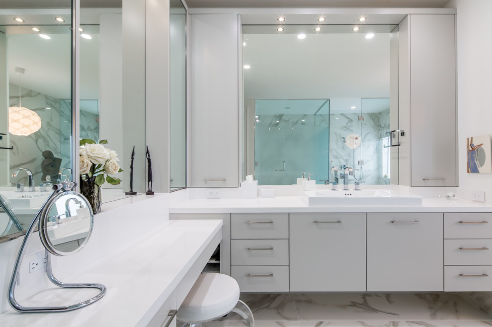 Expansive contemporary master bathroom in Miami with a drop-in sink, flat-panel cabinets, grey cabinets, engineered quartz benchtops, a freestanding tub, a curbless shower, white tile, porcelain tile, white walls and porcelain floors.