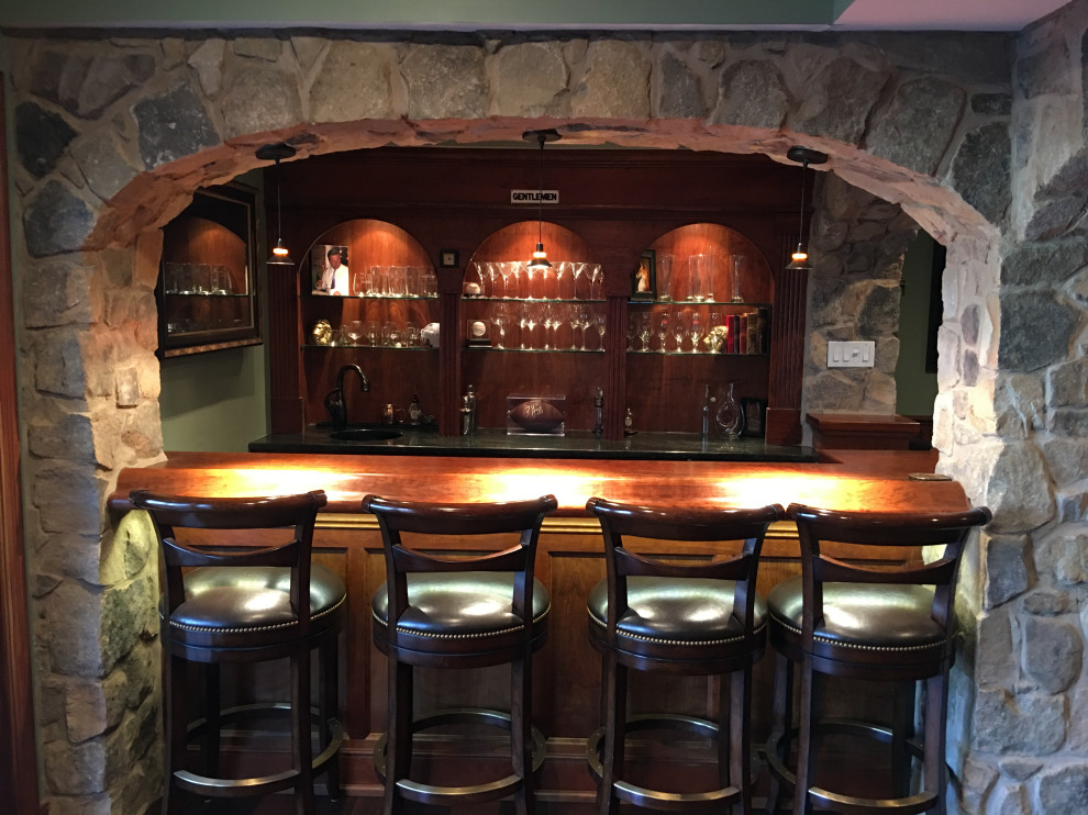 Large traditional home bar in Philadelphia with dark hardwood floors and brown floor.