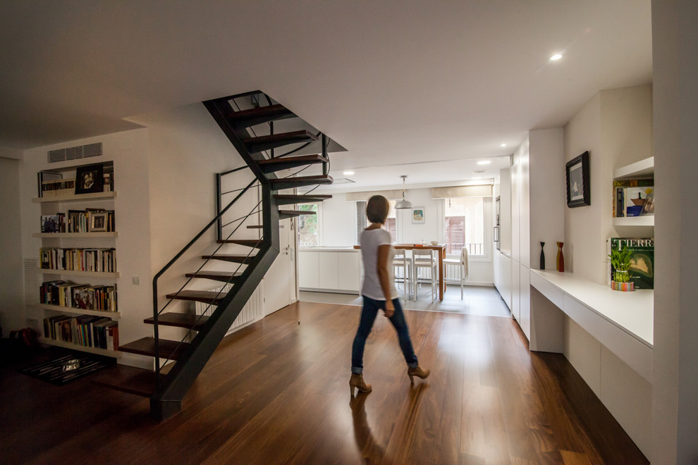 Photo of a large contemporary hallway in Barcelona with white walls and medium hardwood floors.