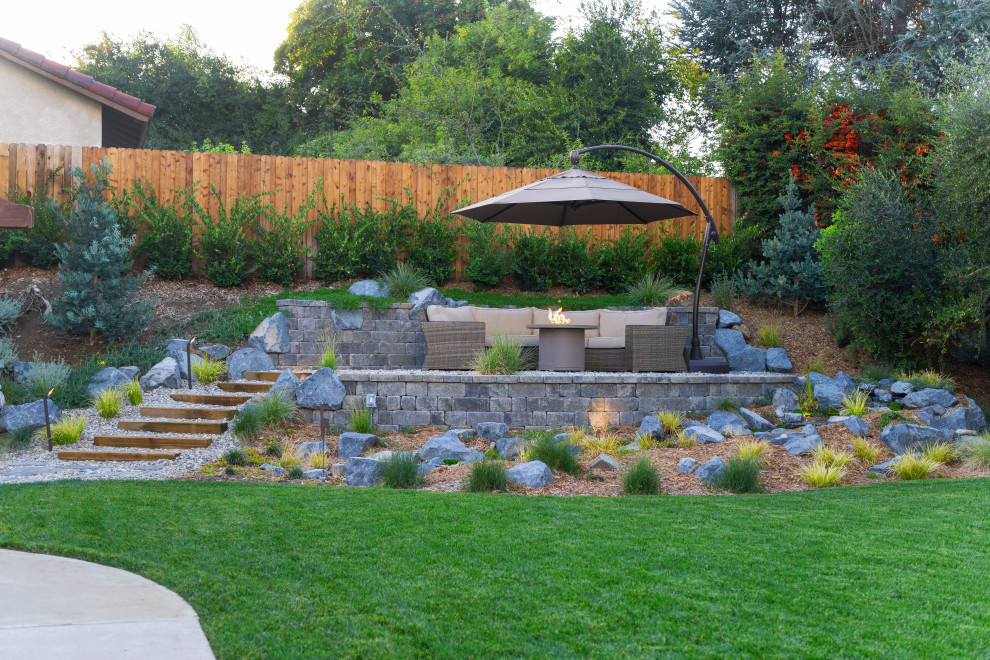Cette image montre une terrasse chalet de taille moyenne avec un foyer extérieur et un gravier de granite.