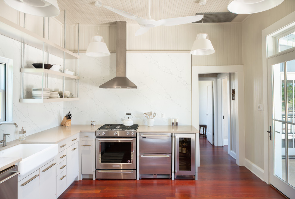 Inspiration for a mid-sized country l-shaped separate kitchen in Austin with a farmhouse sink, open cabinets, grey cabinets, quartzite benchtops, white splashback, stone slab splashback, stainless steel appliances, medium hardwood floors, no island, red floor, grey benchtop and wood.