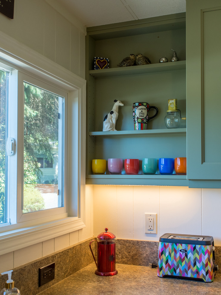Example of a small transitional u-shaped vinyl floor enclosed kitchen design in Seattle with a drop-in sink, recessed-panel cabinets, green cabinets, laminate countertops, brown backsplash, stainless steel appliances, no island and brown countertops